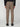 A person is shown from the back against a plain light background wearing PROJEK RAW MENS SOLID BUNGEE CARGO JOGGER pants in taupe with cargo pockets and elastic cuffs, paired with black shoes and a black long-sleeve shirt.