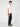 A man with curly hair stands sideways in a plain white t-shirt, brown loafers, and PROJEK RAW MENS SOLID BUNGEE RELAXED 5-POCKET PANT against a plain white background.