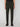 A person wears PROJEK RAW MENS SOLID BUNGEE RELAXED CARGO PANT in dark green, featuring a bungee waistband and buttoned flap thigh pockets, paired with black dress shoes against a plain light background.