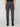 A person wearing PROJEK RAW MEN’S CANVAS BUNGEE PULL-ON CARGO JOGGER in dark gray and black shoes is shown from the back against a plain light background. The joggers have flap back pockets and large side cargo pockets.