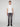 A person stands facing forward against a plain light background, wearing a white short-sleeve t-shirt, black shoes, and PROJEK RAW MENS BARU5-POCKET STRAIGHT FIT DENIM PANT in dark gray.