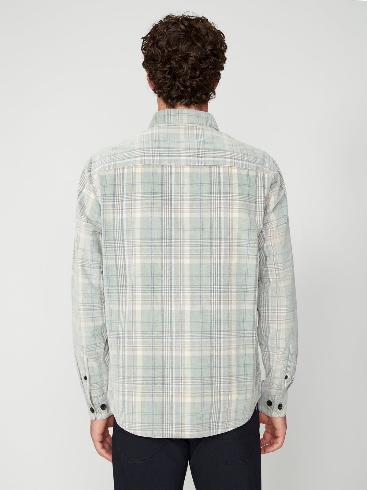 A person with curly hair is seen from the back in a PROJEK RAW MENS LONG SLEEVES PLAID CORDUROY SHIRT and dark pants, styled for a casual look, standing against a plain white background.
