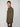 A young man with short light brown hair models the PROJEK RAW MENS LONG SLEEVES KNIT FLANNEL SHIRT in olive green, paired with dark pants and posed sideways against a plain light gray background, looking at the camera.