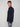 A young man with short light brown hair models the PROJEK RAW MENS LONG SLEEVES KNIT FLANNEL SHIRT and blue jeans, standing sideways and looking at the camera against a plain light background.