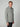A man with short light brown hair models the PROJEK RAW MENS LONG SLEEVE SHERPA LINED OVERSHIRT—gray with chest pockets and black buttons—standing against a plain light gray background.