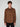 A young man with curly brown hair wears the PROJEK RAW MENS LONG SLEEVE FAUX SUEDE OVERSHIRT in brown, featuring two zippered chest pockets. He stands facing forward against a plain light gray background.