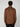 A man with curly hair, facing away from the camera, wears the PROJEK RAW MENS LONG SLEEVE FAUX SUEDE OVERSHIRT in brown and black pants against a light gray background—perfect as a lightweight layer.