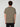 A person with short curly hair faces away from the camera, wearing a PROJEK RAW MENS SHORT SLEEVE CREW NECK T-SHIRT in olive green and black pants against a light gray background—perfect for any casual wardrobe.