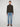 A person faces forward in a dark quarter-zip sweater, PROJEK RAW MENS BARU STRAIGHT FIT STRETCH JEAN, and brown boots, set against a plain light background.