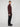 A man stands sideways against a plain gray background, wearing a maroon zip-up sweater, black shoes, and PROJEK RAW MENS BARU STRAIGHT FIT COLORED DENIM JEAN in black.