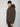 A young man in a black beanie and the PROJEK RAW MENS PUFFER JACKET WITH HOOD stands against a light gray background, looking at the camera. This insulated jacket delivers lightweight warmth for chilly days.
