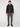 A young man faces forward wearing the PROJEK RAW MENS MOTO JACKET WITH REMOVABLE HOODED DICKIE, styled with dark gray pants, a black t-shirt, and black boots against a plain white background.