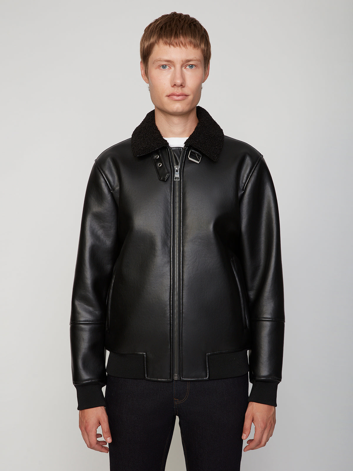 A person with short brown hair wears the PROJEK RAW MENS PU SHERPA LINED JACKET, facing forward against a plain, light gray background.