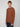 A young man with short light brown hair models the PROJEK RAW MENS HOODED LONG SLEEVE KNIT and blue jeans, standing against a plain light gray background and looking directly at the camera with a neutral expression.