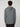 A person with curly brown hair is seen from behind, wearing the PROJEK RAW MENS HOODED LONG SLEEVE KNIT in gray and black pants, creating a casual look against a plain, light background.