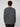 A person with curly brown hair stands with their back to the camera, wearing the PROJEK RAW MENS LONG SLEEVE CREW NECK KNIT and black pants, creating a relaxed, casual look against a plain light gray background.