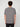 A person with curly brown hair, seen from behind, wears a PROJEK RAW MENS SHORT SLEEVE CREW NECK GRID JERSEY OVERSIZE TSHIRT in textured gray and black pants, showcasing a relaxed style against a plain light background.