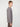 A person with short, light brown hair models the PROJEK RAW MENS LONG SLEEVE HENLEY GRID JERSEY and dark pants, standing sideways against a plain white background.