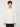 A young man with curly brown hair wears a PROJEK RAW MENS LONG SLEEVE HENLEY GRID JERSEY in off-white and black pants, standing against a plain white background and facing the camera with a neutral expression.