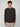 A young man with curly brown hair wears a PROJEK RAW MENS LONG SLEEVE CREW NECK in dark brown and light beige pants, standing facing forward against a plain light gray background.