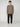 A person stands facing forward against a plain light gray background, wearing the PROJEK RAW MENS LONG SLEEVE CREW NECK in olive green, paired with black cargo joggers and white sneakers.