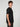 A young man with curly brown hair stands in side profile, modeling the PROJEK RAW MENS SHORT SLEEVE SCUBA JERSEY RELAXED FIT TSHIRT in black and dark pants against a light gray background—ideal for casual wear.
