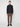 A person with short light brown hair wearing a PROJEK RAW MENS 1/4-ZIP CASHMERE TOUCH SWEATER, brown slim-fit pants, and black shoes stands facing forward against a plain light gray background.
