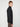 A person with short light brown hair, wearing the PROJEK RAW MENS 1/4-ZIP CASHMERE TOUCH SWEATER in black and brown pants, stands in profile against a plain white background.