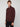 A man wears a maroon PROJEK RAW MENS 1/4-ZIP CASHMERE TOUCH SWEATER and black pants, standing against a plain light gray background, looking slightly to the side with a neutral expression.