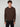 A young man with curly brown hair wears a PROJEK RAW MENS CASHMERE TOUCH HOODIE SWEATER and black pants, standing against a light gray background, facing the camera with a neutral expression.