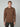 A young man with short light brown hair wears a PROJEK RAW MENS CASHMERE TOUCH HOODIE SWEATER with front pockets and dark pants, standing against a plain light gray background and looking straight at the camera.