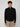 A young man with curly brown hair models the PROJEK RAW MENS ZIP-UP CASHMERE TOUCH SWEATER and beige jeans, standing before a plain light gray background and looking straight at the camera with a neutral expression.