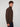 A man with curly brown hair models the PROJEK RAW MENS ZIP-UP CASHMERE TOUCH SWEATER and navy pants, standing sideways against a plain light gray background while looking at the camera.