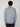 A man with curly hair stands with his back to the camera, wearing a light gray PROJEK RAW MENS ZIP-UP CASHMERE TOUCH SWEATER and dark pants against a plain white background.