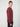 A man with short light brown hair models the PROJEK RAW MENS CREW NECK CASHMERE TOUCH SWEATER in maroon with dark pants, standing sideways and looking at the camera against a plain light background.