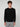 A young man with curly brown hair wears a PROJEK RAW MENS CREW NECK CASHMERE TOUCH SWEATER and light gray plaid pants, standing against a plain light gray background, looking at the camera with a neutral expression.