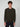 A young man with curly brown hair wears a PROJEK RAW MENS CREW NECK CASHMERE TOUCH SWEATER in dark olive green and dark pants, standing against a light gray background and facing the camera with a neutral expression.