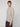 A person with short, light brown hair wears the PROJEK RAW MENS CREW NECK CHENILLE SWEATER in light beige with dark pants, standing against a plain light gray background and facing slightly to the side with a neutral expression.