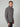 A young man with short, light brown hair wears a PROJEK RAW MENS CHENILLE MOCK NECK SWEATER in grey and black pants, standing against a plain light grey background.