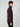 A young man with short curly hair stands sideways against a plain light background, wearing black pants and a PROJEK RAW MENS CHENILLE MOCK NECK SWEATER in dark purple.