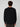 A man with curly brown hair is seen from behind, wearing a black PROJEK RAW MENS SHAKER RIB KNIT SWEATER and dark pants, standing against a plain light gray background.