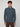 A young man with curly brown hair wears the PROJEK RAW MENS 1/4 ZIP JACQUARD KNIT MOCK NECK SWEATER in blue and brown pants, standing against a plain light gray background.