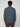 A person with short, curly brown hair is seen from behind, wearing the PROJEK RAW MENS 1/4 ZIP JACQUARD KNIT MOCK NECK SWEATER in blue with brown pants against a plain light gray background.
