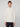 A man with short light brown hair models the PROJEK RAW MENS 1/4 ZIP JACQUARD KNIT MOCK NECK SWEATER in cream and dark pants, standing against a light gray background and facing the camera with a neutral expression.