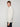 A young man with short light brown hair models the PROJEK RAW MENS 1/4 ZIP JACQUARD KNIT MOCK NECK SWEATER and black pants, standing sideways with a neutral expression against a plain light background.