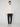 A person stands against a plain background wearing the PROJEK RAW MENS 1/4 ZIP JACQUARD KNIT MOCK NECK SWEATER, dark pants, and white sneakers. They face forward with a neutral expression and arms at their sides.
