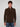 A man with short curly brown hair wears the PROJEK RAW MENS CHENILLE MOCK NECK SWEATER in textured dark brown and blue jeans, standing against a plain light gray background.