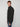 A man with short light brown hair models the PROJEK RAW MENS FULL ZIPPED KNIT SWEATER BONDED POLAR FLEECE in dark gray with blue jeans, standing slightly to the side against a plain light background.