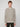 A person with short light brown hair wears the PROJEK RAW MENS FULL ZIPPED KNIT SWEATER BONDED POLAR FLEECE in beige, featuring a subtle knit texture, and stands against a plain light gray background.