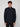 A young man with curly brown hair models the PROJEK RAW MEN’S 1/4 ZIP MOCK NECK PULLOVER SWEATER in dark blue and black pants, standing against a light gray background and facing the camera with a neutral expression.